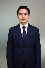 Portrait Asian business man standing look at camera  in modern office.