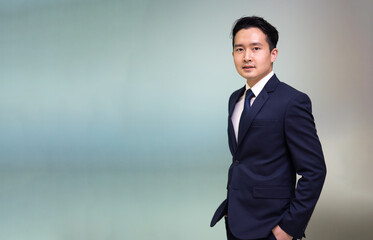 Portrait Asian business man standing look at camera  in modern office.