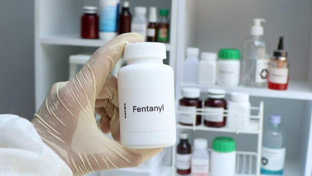 Fentanyl pill in white bottle, pill stock, medical or pharmacy concept