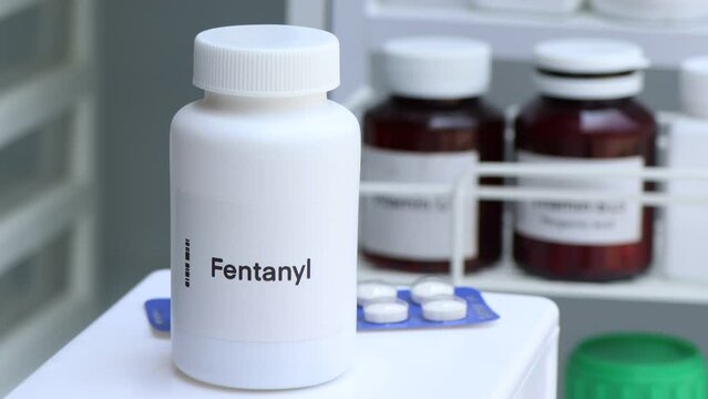 Fentanyl pill in white bottle, pill stock, medical or pharmacy concept
