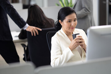 young asian business woman working on desk with desktop computer in modern home office.