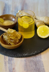 lemon and honey, healthy drink made from lemon, ginger and honey on a black board, honeycomb, lemon