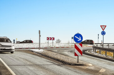 View of road with traffic signs on winter day