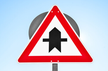 Priority road sign against blue sky, closeup