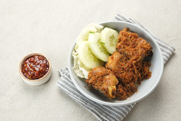 Ayam Goreng Lengkuas, fried chicken cooked with spices and sprinkled with grated galangal. Indonesian traditional food.  
