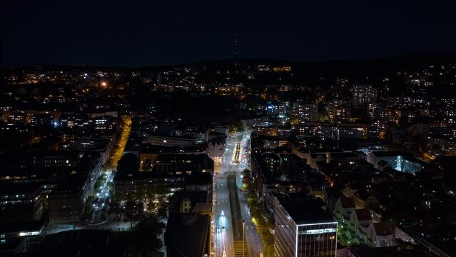 night illumination flight over stuttgart cityscape center traffic street square aerial topdown panorama 4k timelapse germany