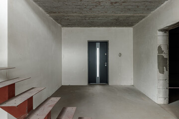 Repairs in the building. Building with a metal staircase at the time of renovation. Construction site in the house without people. Construction of a new house. Construction and architecture