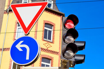 View of traffic lights with road signs in city, closeup