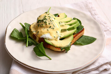 Plate with tasty egg Benedict on napkin, closeup