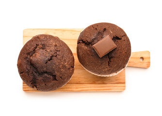 Wooden board with tasty chocolate cupcakes isolated on white background