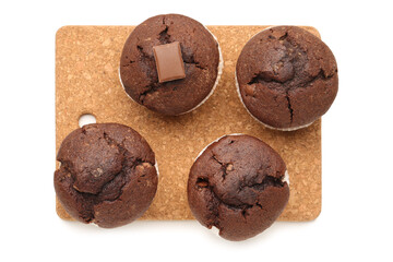 Board with tasty chocolate cupcakes isolated on white background