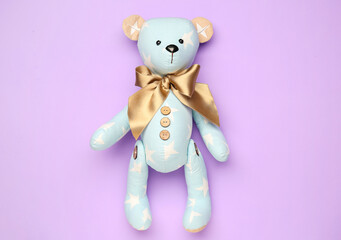 Toy bear on lilac background