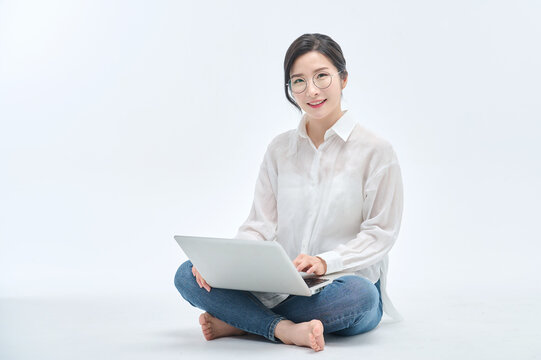 beautiful woman using a laptop on a white background