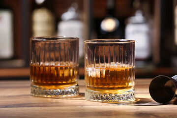 Glasses of cold rum on table in bar