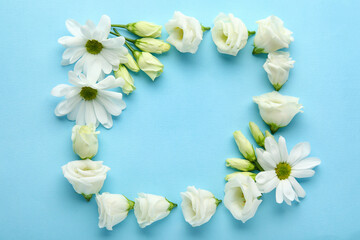 Frame made of beautiful eustoma and chamomile flowers on color background