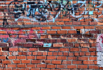 An old painted brick wall on a spring day