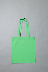 High angle view of green canvas bag with copy space on grey background