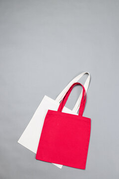Close up of white and red canvas bags with copy space on grey background