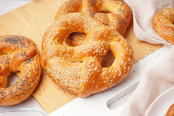 Board with tasty pretzels, closeup