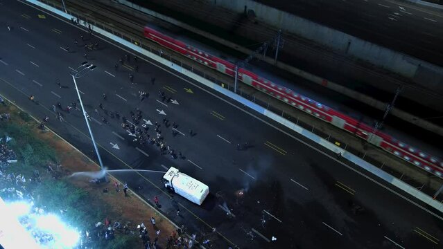 Police and demonstrators clashing on tel aviv highway

Tel aviv, ISRAEL - march 30 2023,drone view
