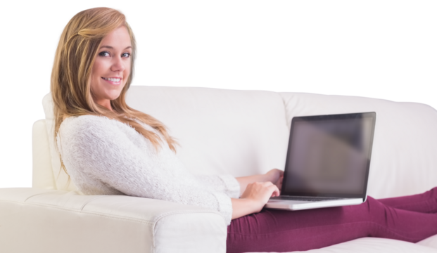 Pretty blonde relaxing on sofa with laptop