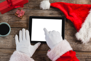 Santa Claus using digital tablet on table