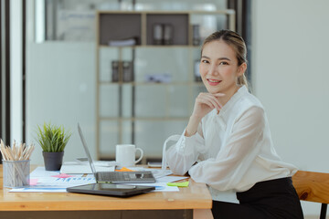 Technology and financial advisory services concert. Business woman working on digital tablet and laptop computer with advisor showing plan of investment to clients at table office. Digital marketing.