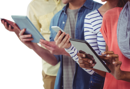 Smiling creative team standing in a line using technology