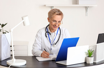 Mature female doctor video chatting with patient. Concept of telemedicine