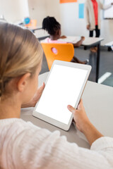 Girl holding digital tablet and sitting