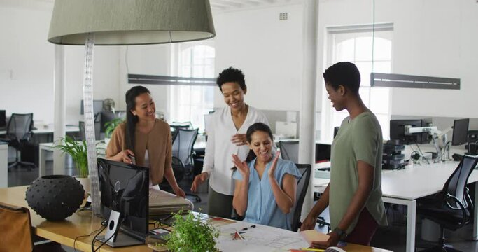 Group of happy diverse businesswomen working together in office