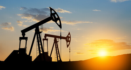 The change in oil prices caused by the war. Oil price cap concept. Oil drilling derricks at desert...