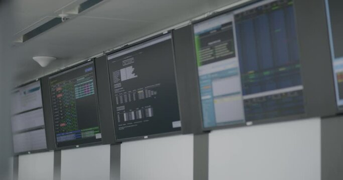 Interior airport control center showing screens with data in tables, slide right