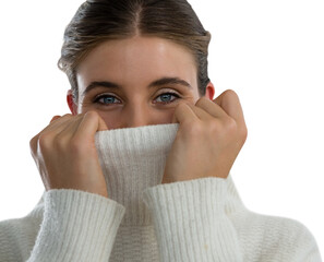 Portrait of young woman covering face with turtleneck sweater