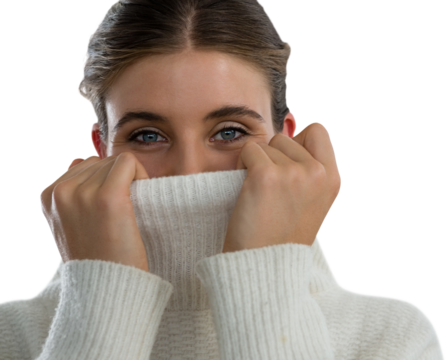 Portrait of young woman covering face with turtleneck sweater - Powered by Adobe