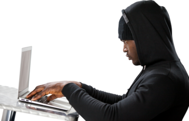Male hacker using laptop 