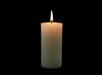 One white burning candle isolated on black background.