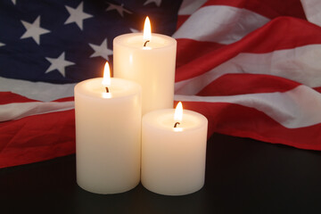 Burning candles on USA flag background. Memorial day concept.