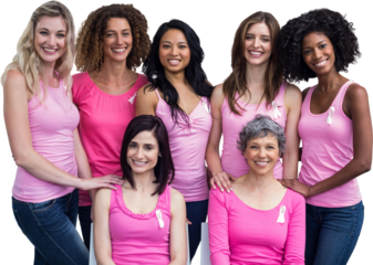 Smiling women in pink outfits posing for breast cancer awareness