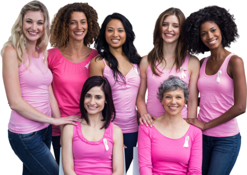 Smiling women in pink outfits posing for breast cancer awareness