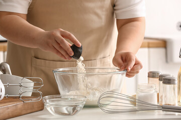 Woman preparing dough for Italian Grissini at table in kitchen, closeup