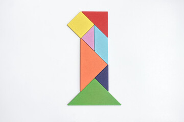 color tangram puzzle in number 1 shape on white background