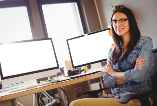 Portrait of happy graphic designer sitting at office - Powered by Adobe