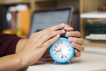 Holding an alarm clock in hand, close-up shot