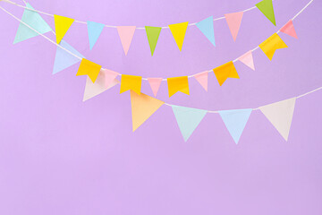Colorful flags for Festa Junina on lilac background