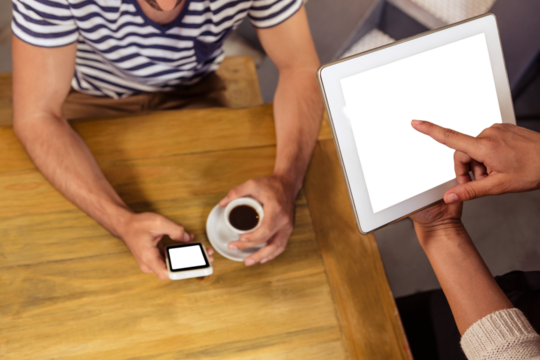 Woman pointing at digital tablet by man