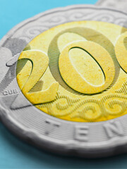 Translation: tenge. Kazakh money. Coin 200 tenge close-up. Economy and Central Bank of Kazakhstan. Finance and business. Vertical illustration. Tinted in colors of national flag. Macro
