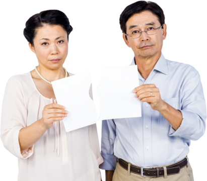 Couple holding torn paper