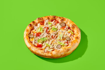 Caesar-style pizza with chicken, lettuce, tomatoes, capers, and Caesar dressing on a green backdrop. Minimalist food photography featuring hard shadows, modern aesthetics, and vibrant colors