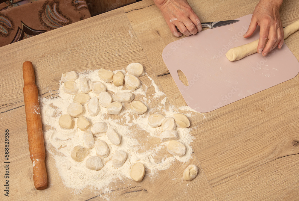 Sticker Cutting dough with a knife.